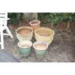 A quantity of terracotta and glazed planters