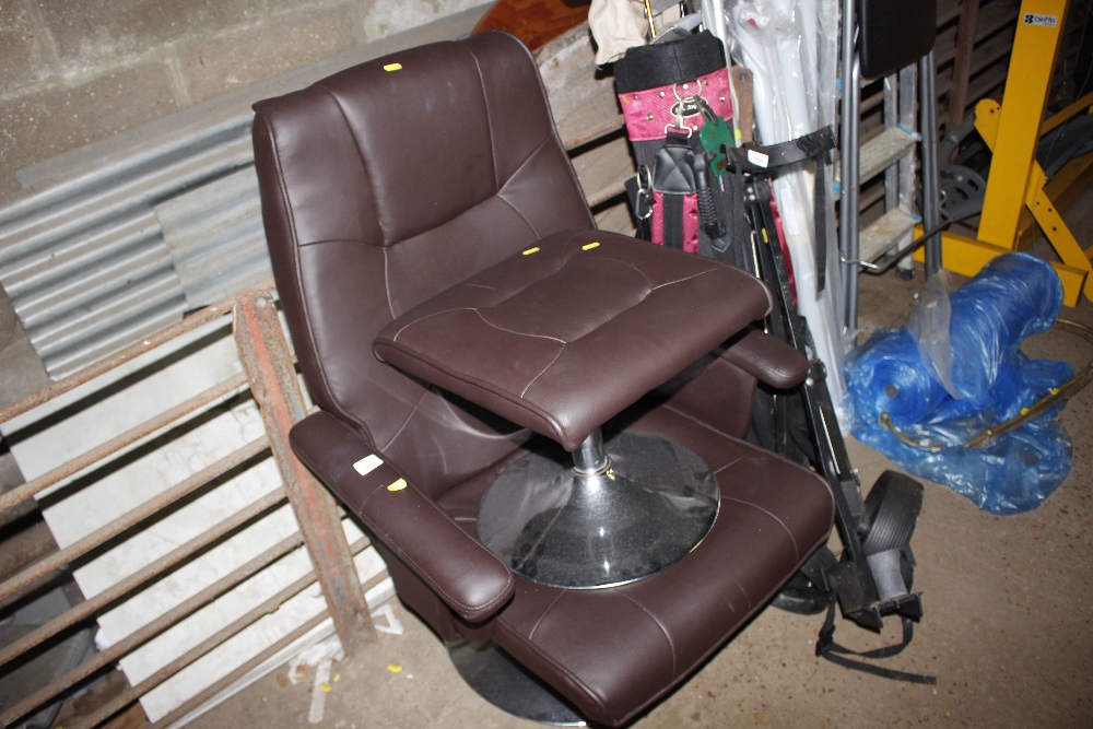 A faux leather upholstered armchair and foot stool