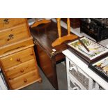 A mahogany drop leaf table with pad feet