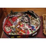 A tin of various costume jewellery