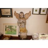 An antique carved wooden angel figure