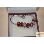 A boxed Pandora bracelet set with seven beads