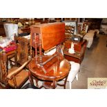 An Edwardian walnut Sutherland tea table; and an E