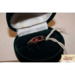 A silver and red stone set dress ring