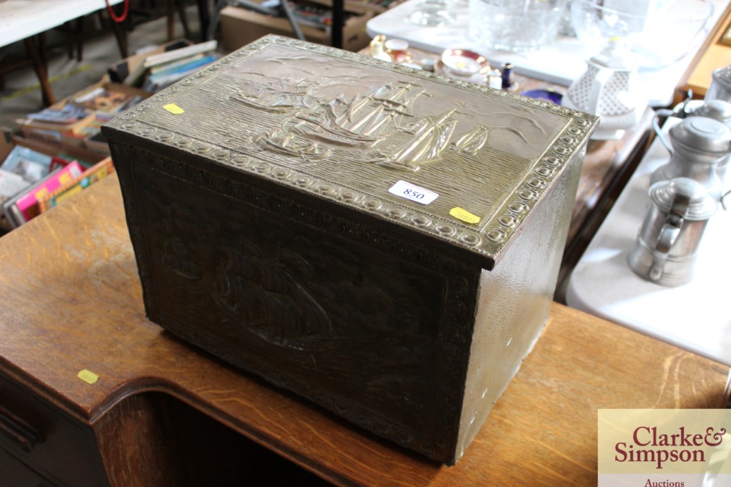 A brass embossed coal box, decorated with boating
