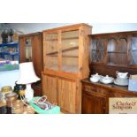 A pine kitchen dresser with glazed doors to top