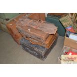 Three leather suitcases and a canvas bag