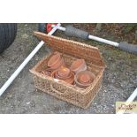 A basket of terracotta plant pots