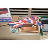A box containing vintage flags, stool and wooden b