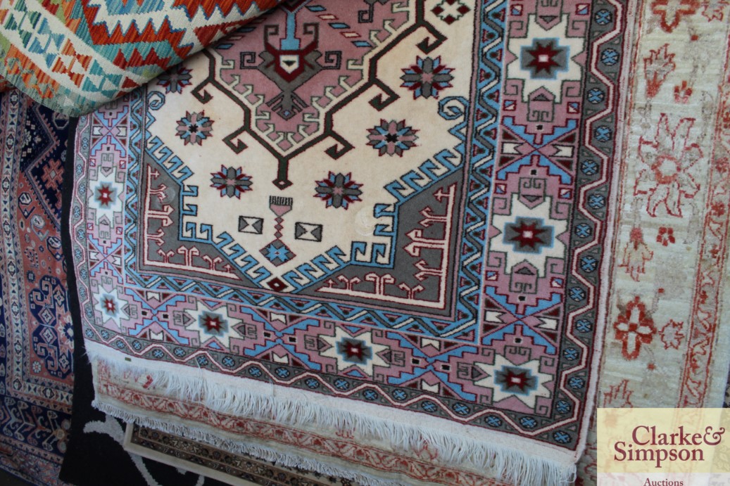 An approximate 7'7 by 4'6 patterned rug