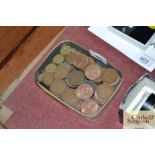 A tin of various vintage coinage including pennies