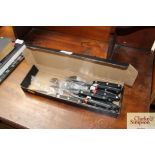 A box of steak knives and forks