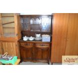 An oak dresser with glazed leaded doors to top and