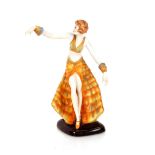 An Art Deco style porcelain figure of a dancing gi