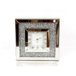 A mirrored and diamanté decorated clock