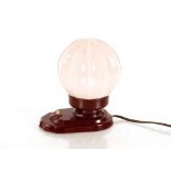 A Bakelite bedside lamp with opaque glass shade, 1