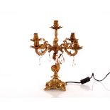 A brass five branch table lamp in the form of a me