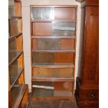A mid 20th Century light oak six section bookcase,