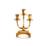 A brass three light candelabra