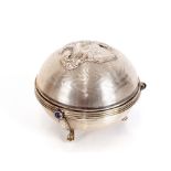 A silver musical box, of circular form, the lid de