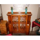 An Art Deco walnut display cabinet, the glass shel