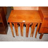 A nest of five teak occasional tables 63cm wide ov