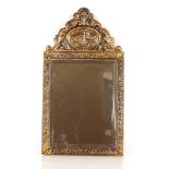 A brass Repoussé decorated bevelled wall mirror, 5