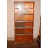 A mid 20th Century light oak six section bookcase,
