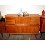A Beautility teak sideboard, having central drinks