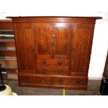 An Arts & Crafts oak linen press, fitted central t