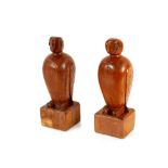 A pair of carved wooden book ends in the form of p