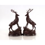 A pair of bronze stag figures