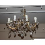 A large eight branch glass chandelier and seven ma