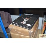 A box containing SLR camera improver course books