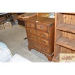 .A reproduction walnut veneered chest fitted two short