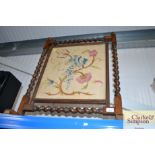 An oak and barley twist fire screen with embroider