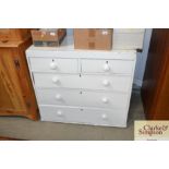 A white painted pine chest fitted two short over t