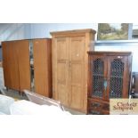 A stripped pine two door cupboard (deep scratches