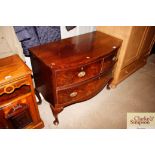 A mahogany bow fronted chest of two short and one