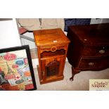 An Edwardian carved walnut bedside cupboard