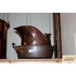 A copper coal helmet and a copper preserve pan