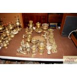 Various brass barrel taps; brass trivets; brass be