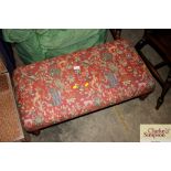 An upholstered foot stool