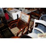 A pair of mahogany scroll armchairs