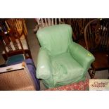 A small green upholstered armchair