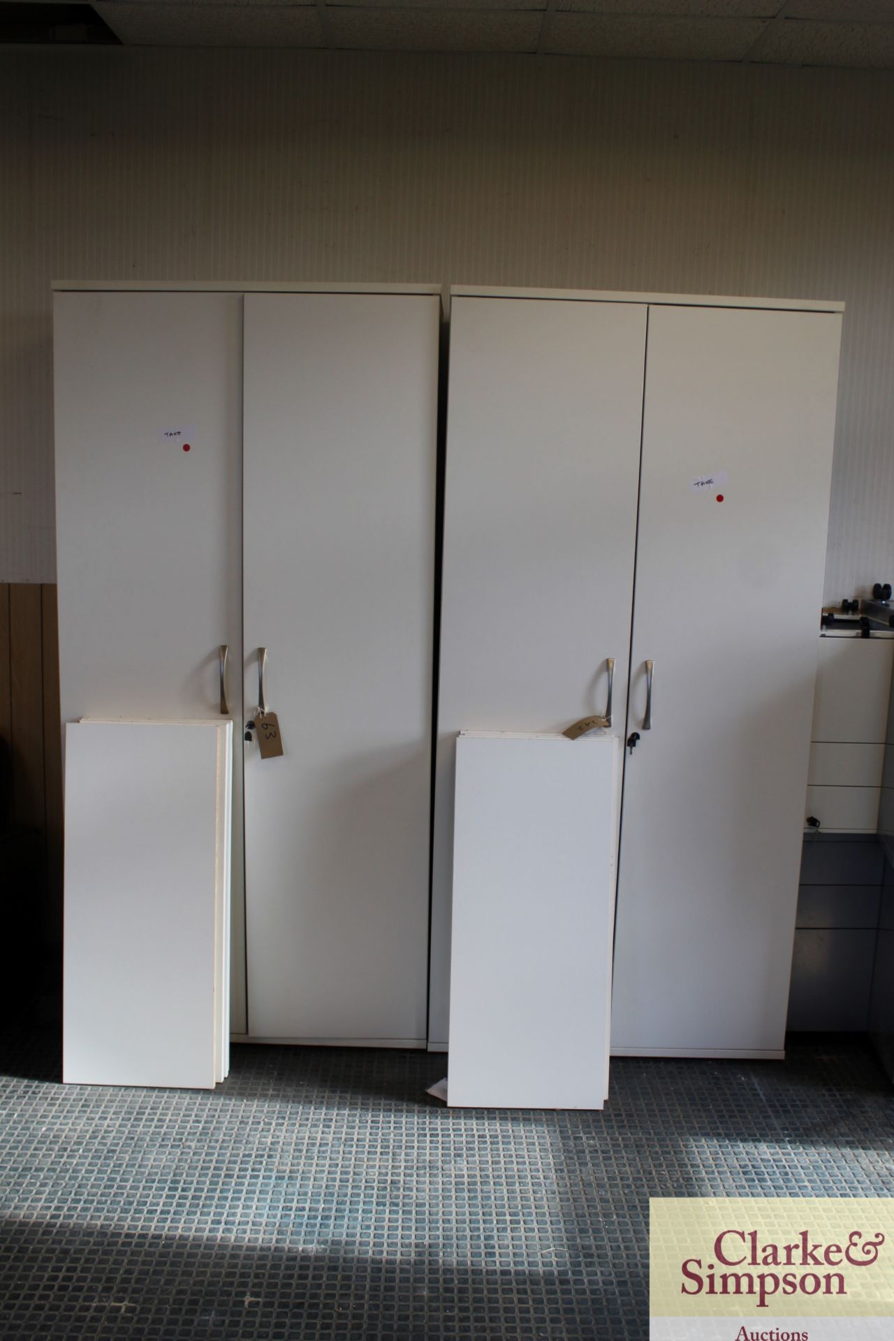 2x white lockable storage cupboards. Each with fou