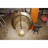 A large Eastern circular brass table top; a smalle