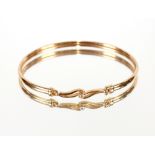 A 9ct gold bangle, set central diamond, approx. 5.3gms