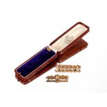 Two 9ct gold bar brooches; and a stick pin with yellow metal terminal (3)