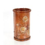 An Arts & Crafts style leather stick stand, having thistle decoration, 24cm dia. 39cm high